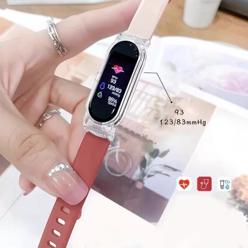 V bunke je text: ApriFit inteligentný náramok v broskyňovej farbe - Štýl a Technológia.