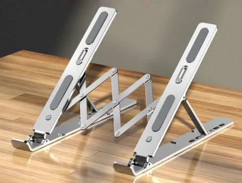 V bunke je text:Držiak na laptop ABS (biely)